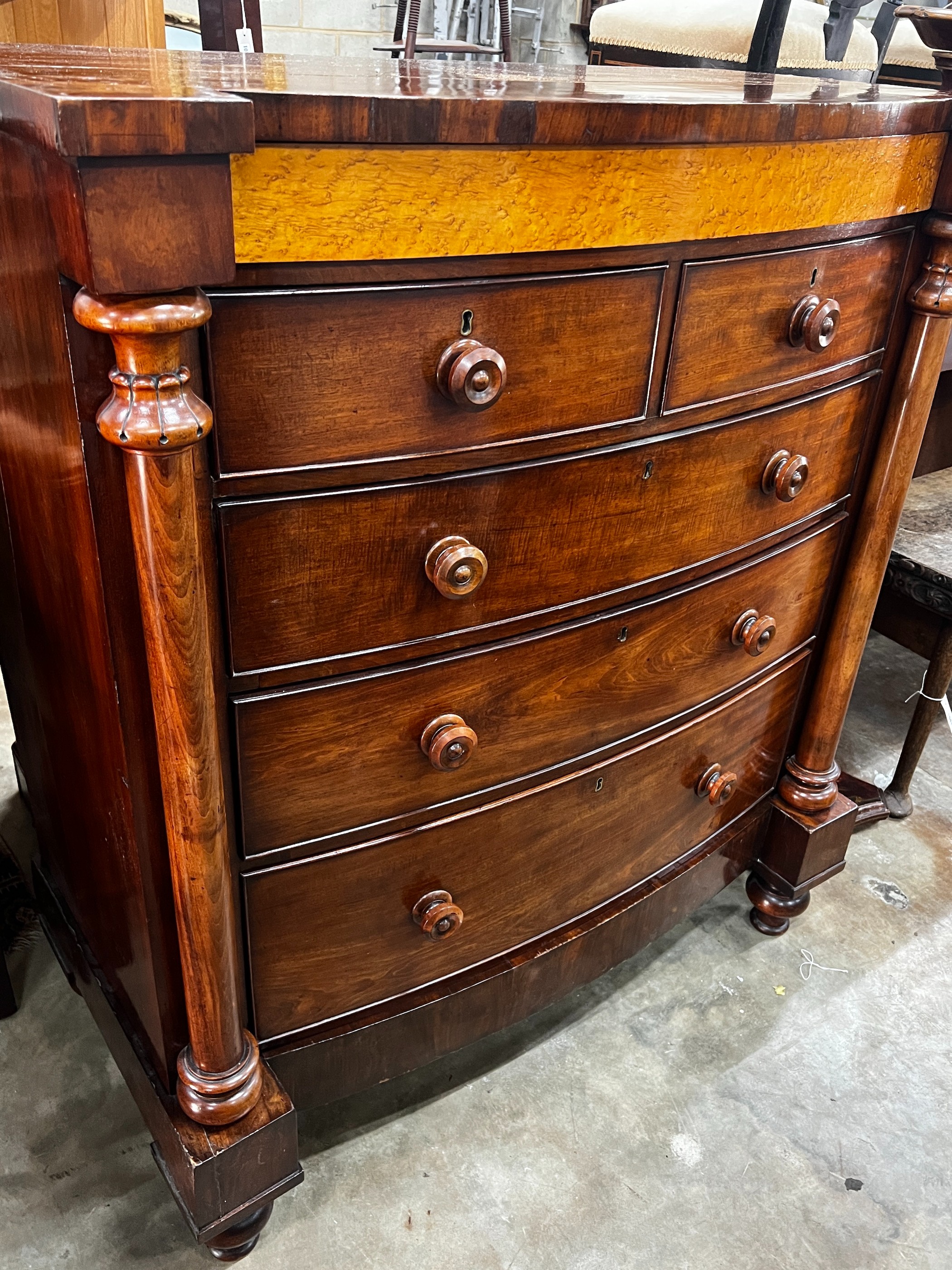 A large mid Victorian mahogany bow front chest of two short and three long drawers, bird's eye maple panel, width 114cm, depth 55cm, height 130cm